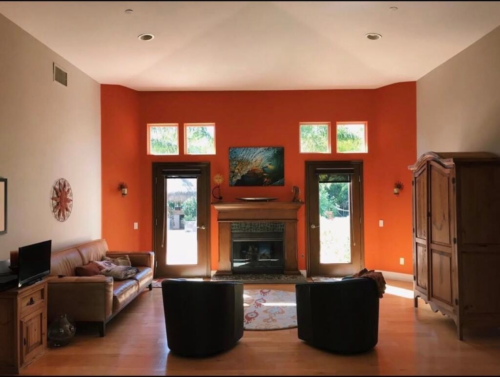 Modern living room with orange accent wall