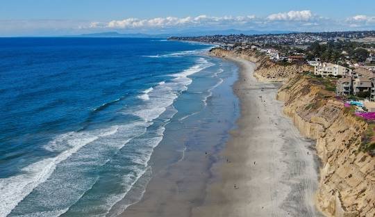 Coastal beach with cliffs and waves