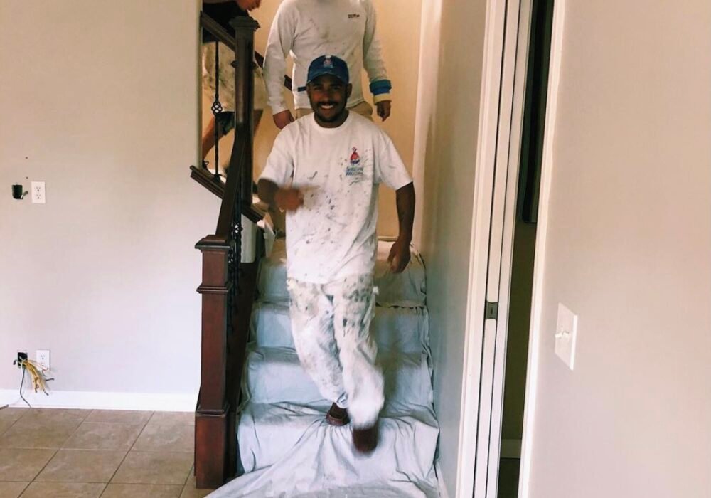 Painting crew preparing interior stairway area